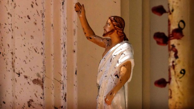 Blood stains are seen on the wall and on a Jesus Christ statue at the St Sebastian's Church near Colombo, Sri Lanka.