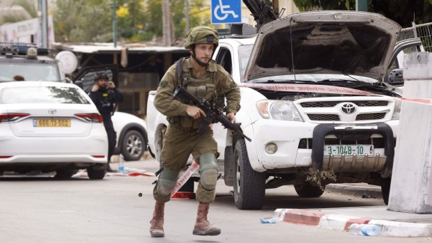 An Israeli soldier near a police station occupied by Hamas soldiers in Sderot, Israel.