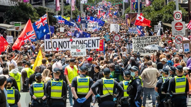 Police look on as protesters gather in Melbourne's CBD.