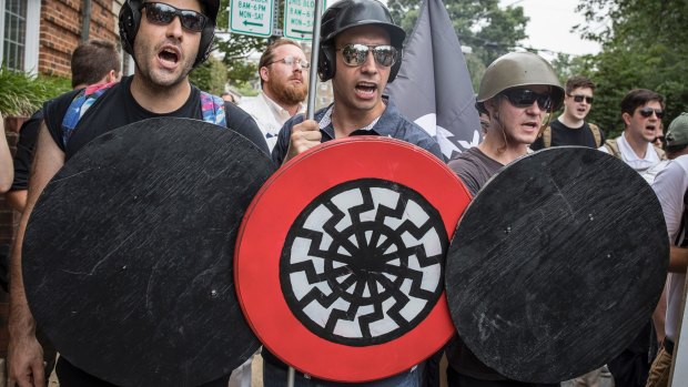 A white supremacist with the black sun on his shield at a Charlottesville  rally in 2017, which turned deadly. 