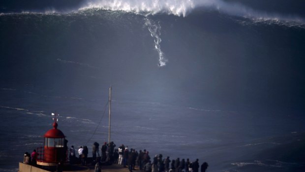 A surfer drops in on a large wave at Praia do Norte, in Nazare. 