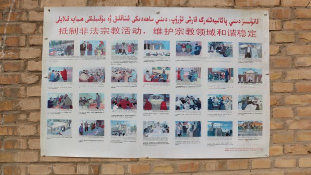 A poster at a mosque in the Xinjiang village of Kuibagh in 2014 shows banned religious practices.