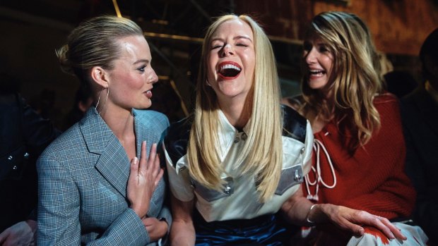 Margot Robbie, left, Nicole Kidman, center, and Laura Dern, right, laugh during the Calvin Klein fashion show in 2018.