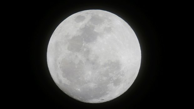 The moon appears in the first supermoon of 2018 as seen from suburban Makati city east of Manila, Philippines on Monday, Jan. 1, 2018. 