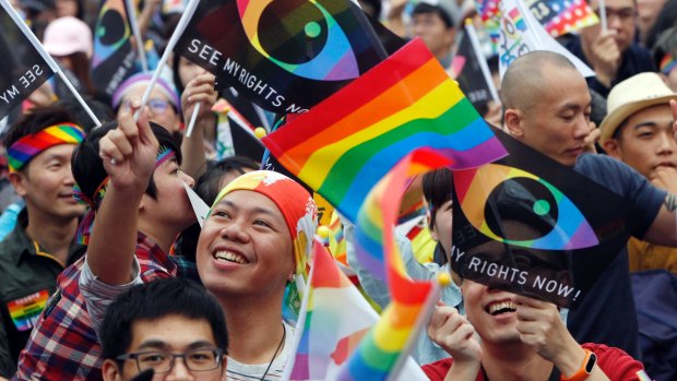Supporters of LGBT and human rights wave rainbow flags during a rally in Tapei in 2016.