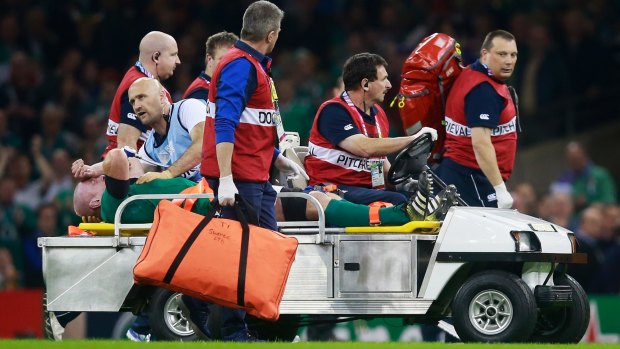 Painful times: Paul O'Connell is stretchered off during Ireland's pool match against France in 2015. 