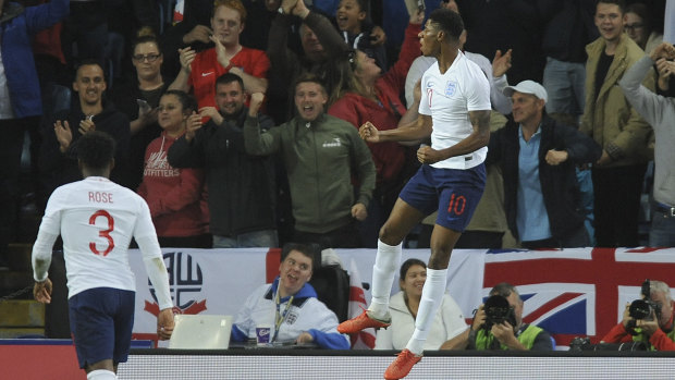 Victory: England's Marcus Rashford celebrates after scoring the only goal in the win against Switzerland.