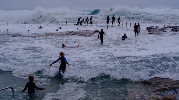 As large south swells lash the coast of NSW, kids swing from the chains of South Curl Curl rock pool.
