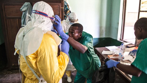 Health workers don protective clothing as they prepare to attend to patients in the isolation ward at Bikoro Hospital earlier this month. 