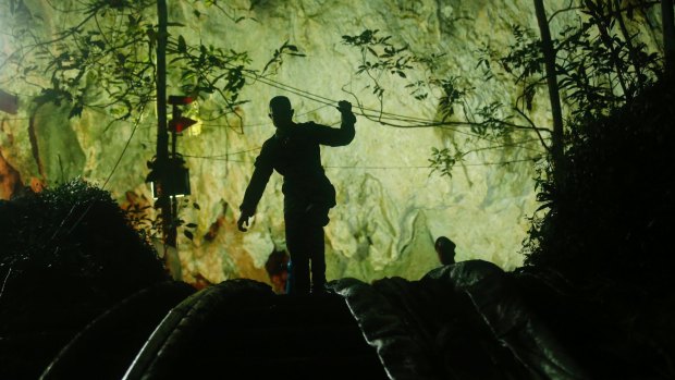 A rescuer makes his way down at the entrance to a cave complex where 12 boys and their soccer coach went missing, in Mae Sai, Chiang Rai province, in northern Thailand.