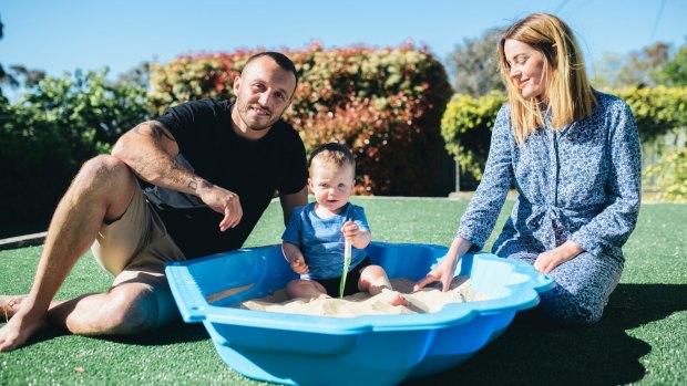 Josh Hodgson at home with his wife Kirby and son George.