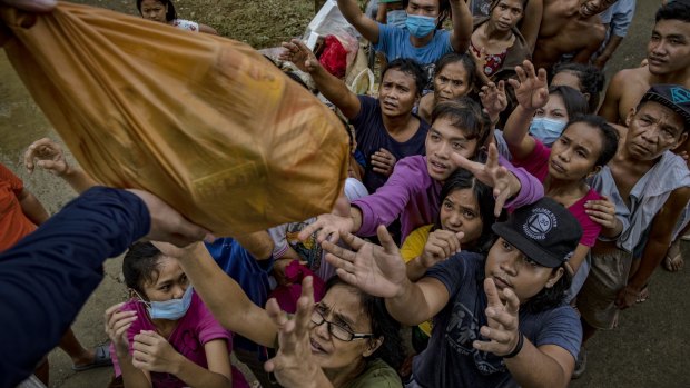 Residents affected by typhoon Vamco queue to receive relief goods in Tuguegarao, Philippines, in November.