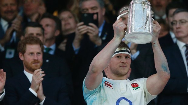 Prince Harry watches as England's Dylan Hartley holds up the Calcutta Cup in 2017.