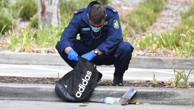 A police officer looks through the teenager's backpack in February 2017.