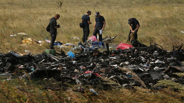 Australian Federal Police officers and their Dutch counterparts search for human remains and personal belongings from the MH17 crash site.