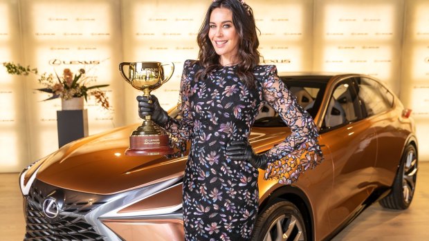 Megan Gale with the Lexus Melbourne Cup in Lexus ahead of the Melbourne Cup Carnival.
