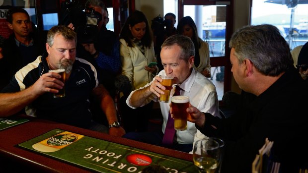 Mr Shorten has a beer with Beaconsfield mine disaster survivors Todd Russell and Brant Webb in Tasmania. 