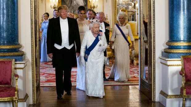 President Donald Trump and first lady Melania Trump walk with the Queen as they make their way into the Music Room for a State Banquet at Buckingham Palace.