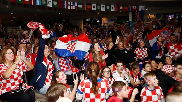 Fans celebrate at King Tom Club in Sydney after the FIFA World Cup semi-final between Croatia and England.
