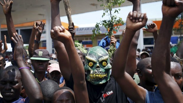A protester wears a mask to hide his identity during a protest against President Pierre Nkurunziza's decision to run for a third term, in Burundi, in 2015. 