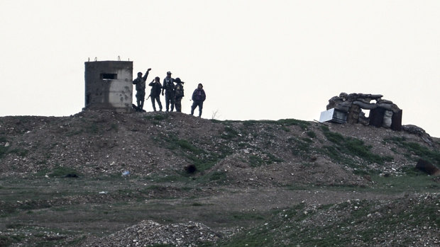 YPG fighters gather west of Kobani, northern Syria, on Tuesday. Turkey has vowed to launch a new offensive against YPG, the main component of a US-allied force that drove IS out of much of eastern Syria.