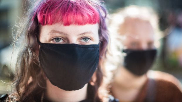 People wearing masks on Brunswick Street, Fitzroy, Melbourne.