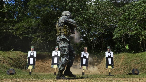 A Filipino marine fires at a target during training.