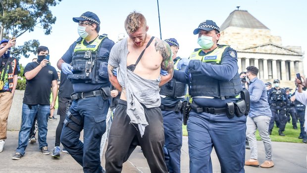 Facebook: a great place to share conspiracy theory and suspicions. Police make an arrest after a scuffle with anti-lockdown protesters at the Shrine of Remembrance.