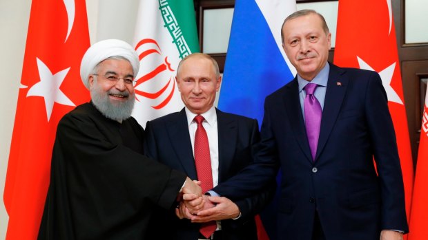 From left, Iranian President Hassan Rouhani, Russian President Vladimir Putin and Turkish President Recep Tayyip Erdogan shake hands last year.