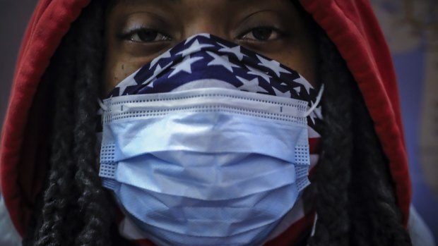 A subway rider wears a mask and a bandana for protection against COVID-19 in New York. The coronavirus has previously been found to be hitting black Americans particularly hard. A new study points to the same situation in the UK. 