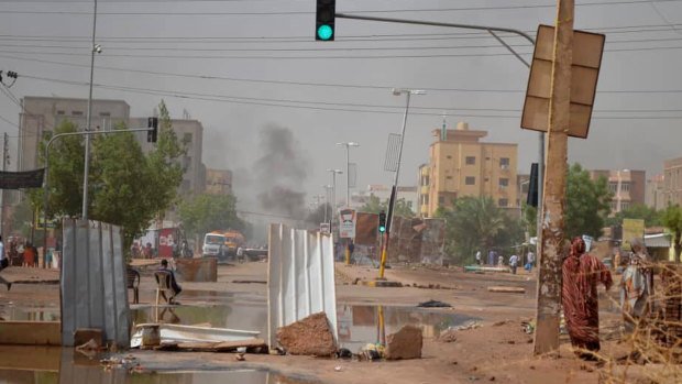 Barricades laid by protesters block a street in Khartoum to stop military vehicles from driving through amid a violent crackdown on pro-democracy protesters.