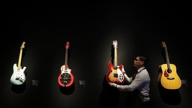 A technician arranges guitars from the collection of David Gilmour, guitarist, singer and songwriter of Pink Floyd, during a press opportunity at Christie's auction rooms in London.