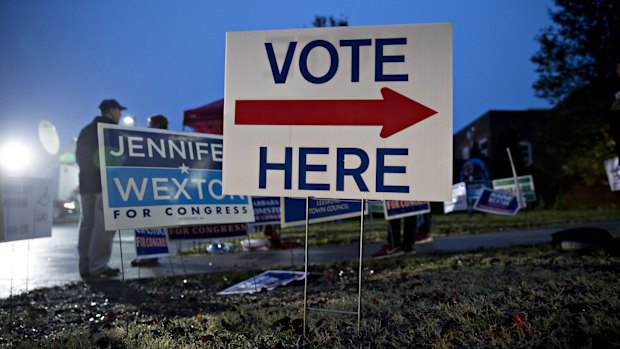 A "Vote Here" sign stands outside a polling station in Leesburg, Virginia, US on Tuesday, November 6, 2018.