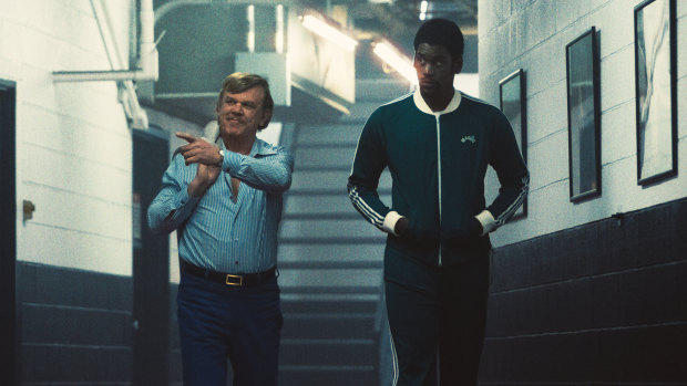 John C. Reilly as Jerry Buss and Quincy Isaiah as Magic Johnson in Winning Time.
