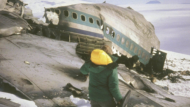A rescue worker walks past the wreckage of an Air New Zealand DC10 plane.