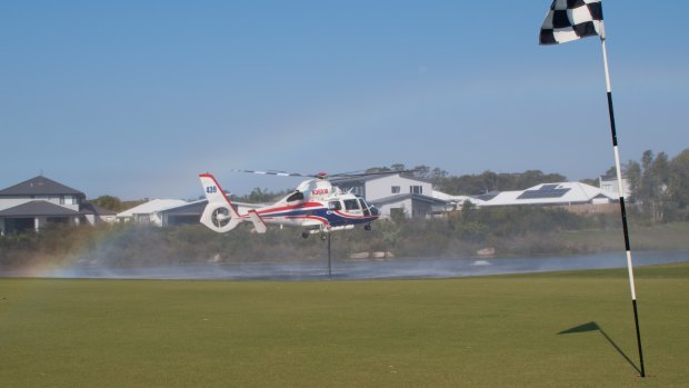 A helicopters takes on water to fight the Sunshine Coast bushfires. 