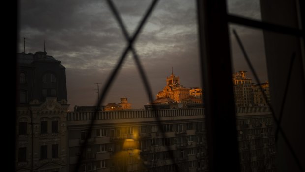 A view of the sunset through windows that have been sealed to avoid the bursting of glass from possible shockwaves in central Kyiv, Ukraine.
