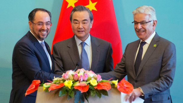 From left, Afghanistan's Salahuddin Rabbani, China's Wang Yi and Pakistan's Khawaja Asif at the first China-Afghanistan-Pakistan Foreign Ministers' Dialogue in Beijing in December.