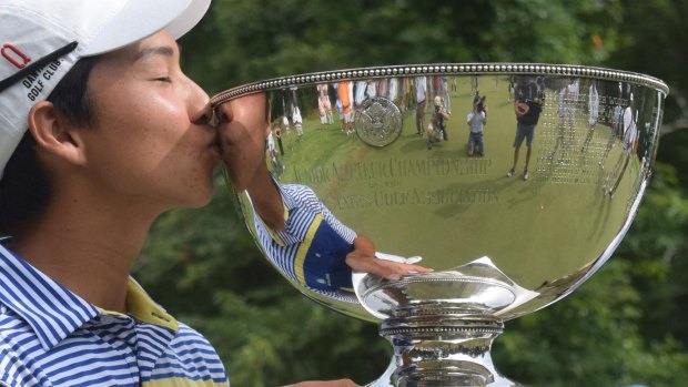 WA's Min Woo Lee kisses the trophy after winning the championship on the final day of the U.S. Junior Amateur golf tournament in 2016.
