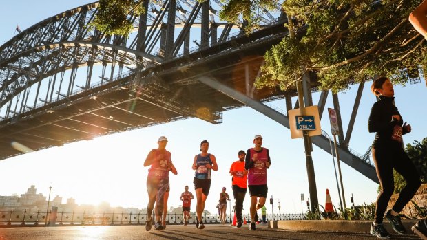 Participants run under the Harbour Bridge on Sunday morning.