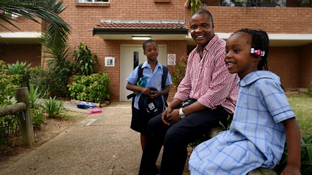 Lamin Tucker with two of his children. The sprinter was captain of the Sierra Leone athletics team at the 2006 Games.