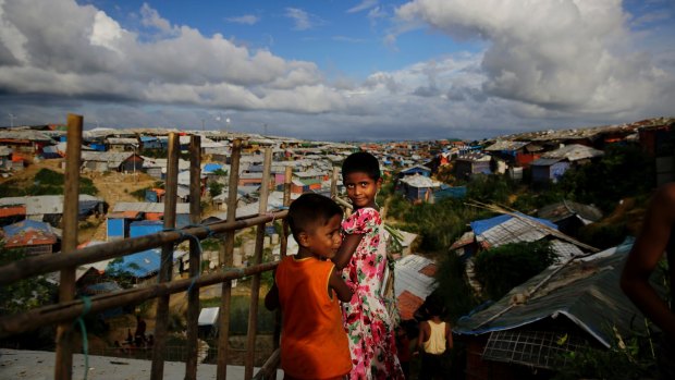 Rohingya children overlook an expanse of makeshift bamboo and tarp shelters at Kutupalong refugee camp.