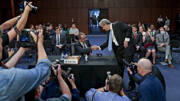 US Senator John Kennedy, a Republican from Louisiana, right, shakes hands with Peiter Zatko at the Senate hearing.