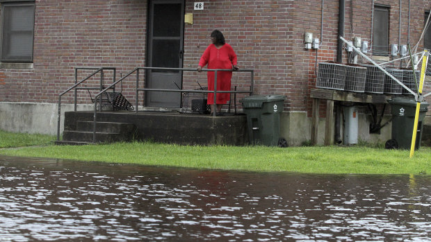 Residents at Trent Court Apartments wait out the weather as rising water gets closer to their doors in New Bern, North Carolina.