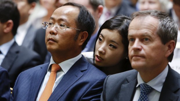 Yuhu Group chairman Huang Xiangmo (left), pictured in 2013, is a billionaire businessman.