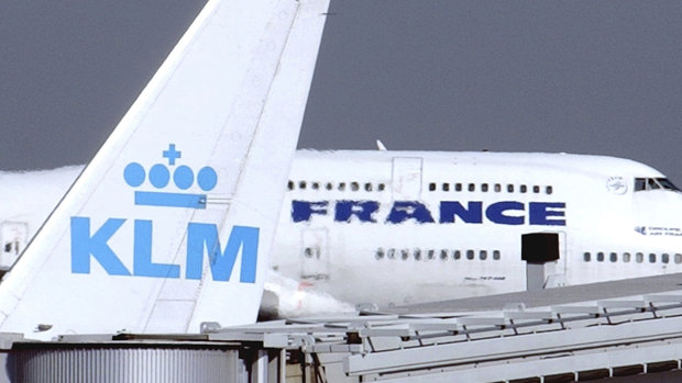 An Air France jumbo jet rolls behind the tail of a KLM Royal Dutch airliner at Charles de Gaulle airport in Roissy, north of Paris. 