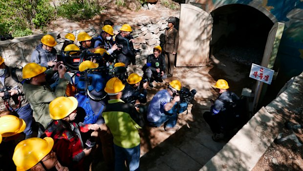 Foreign media crowd the entrance of north tunnel at North Korea's nuclear test site before the explosions.