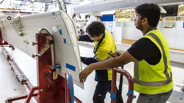 Boeing employees working on a wing component at its Port Melbourne factory in 2014. About 230 of the facility's 1100 staff will be made redundant. 