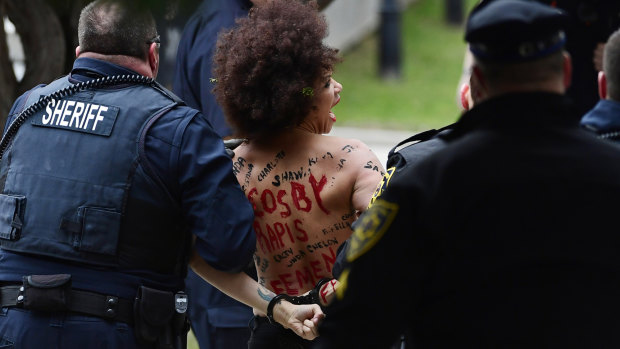 Nicolle Rochelle is taken away after protesting outside Bill Cosby's trial.