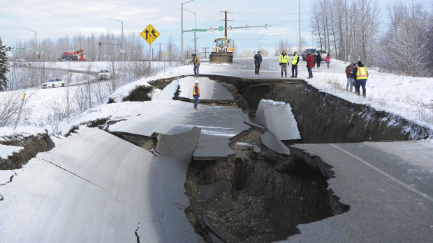 Workers inspect an off-ramp that collapsed during a morning earthquake in Anchorage, Alaska. 